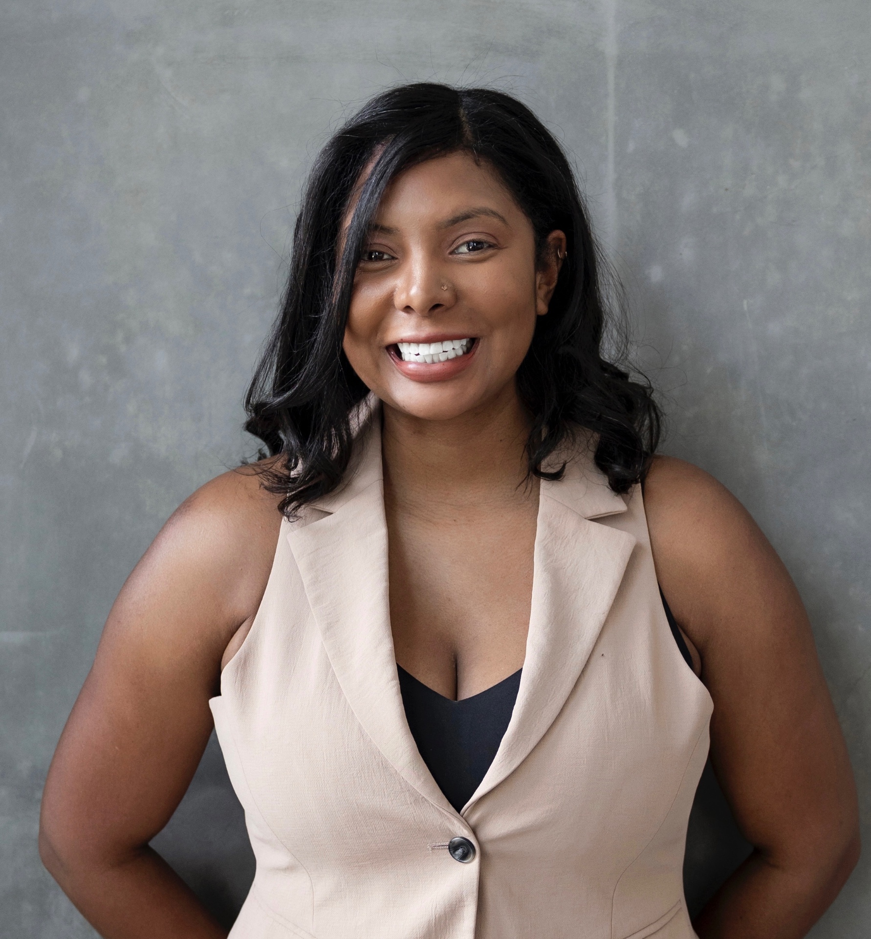 Portrait of Ashleigh Evans smiling in a cream blazer